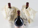 two bottles of wine sitting next to each other on a table
