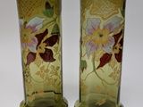 two vases that have been painted with flowers on them