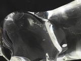 a glass sculpture of a horse that is sitting on a table