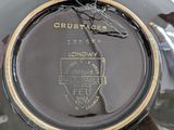 a close up of a black and gold plate with a horse on it