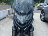 the motorcycle is parked in the parking lot next to a car