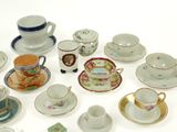 a lot of cups and saucers that are on the table