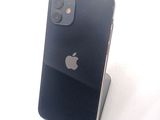 a black iphone sitting on a stand on a white surface