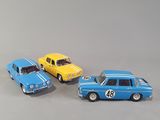 three toy cars sitting next to each other on a table