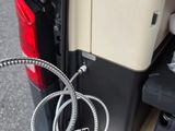 a close up of a car door with a cable attached to it