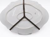 a white plate with a brown ribbon on it