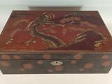 an old wooden box with a dragon design on it