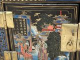 a black box with a painting on it sitting on a table