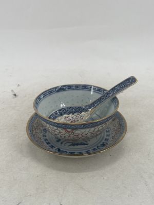 a blue and white bowl with a spoon in it
