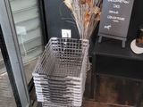 a plant in a basket on the floor next to a door