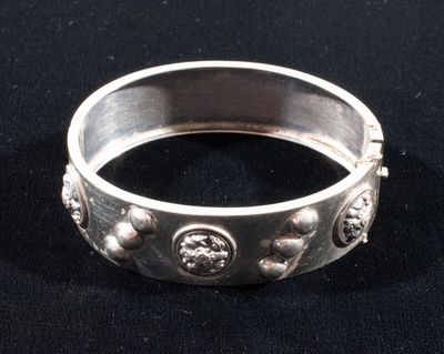 a close up of a silver ring on a black surface