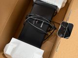 a box with a cell phone and a charger inside of it