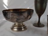 a silver bowl and a silver cup on a white table