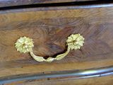 a close up of a wooden dresser with brass handles