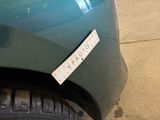 a sticker on the front of a green car