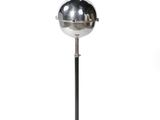 the floor lamp has a metal base and a chrome ball on it