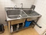 a stainless steel sink in a bathroom with two blue buckets on the floor