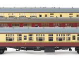 three model trains sitting side by side on a white surface
