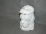 a white ceramic figurine of a bear with a hat on