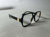 the glasses are black and have gold accents on the temples