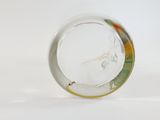 a glass object with a design on it on a white surface