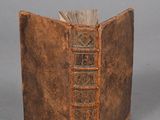 an old book that is open on a table