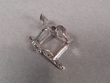 a silver buckle with a bird on it on a table