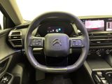 the interior of a car with a steering wheel and dashboard controls