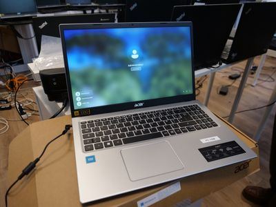a laptop computer sitting on top of a box on a table