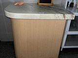 a small counter with a chalk board on top of it
