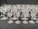 a lot of wine glasses that are sitting on a table