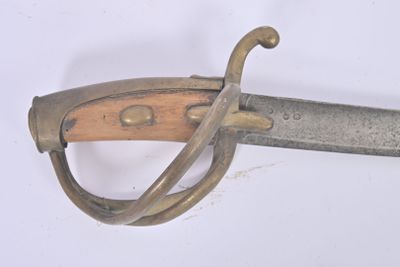 a close up of a sword with a wooden handle