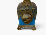 a blue and gold vase with a picture on it