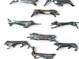a lot of metal animals that are on a white surface