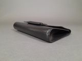 wallet case made of black crocodile skin with a metal clasp