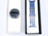 a box with a watch inside of it on a white surface