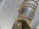 a close up of a metal pipe with a hose attached to it