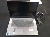 a laptop that is sitting on the floor with a charger