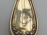 a silver spoon with a design on it on a table