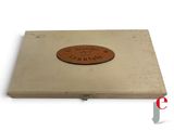 a small wooden box with a brown label on it