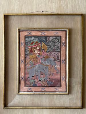 framed painting of a woman riding an elephant with a man on it