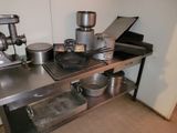 a small kitchen with a stove, sink, and other items on the counter