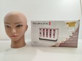 a mannequin head next to a box of hair care products