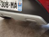a red car with a license plate on the back of it
