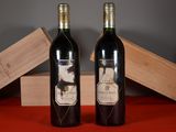 two bottles of wine sitting next to each other on a table