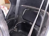 a seat in the back of a car with a seat belt in it