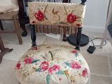 a chair that has a floral seat on it in a living room