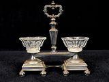 pair of silver plated candlesticks on stand on black background