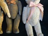 three teddy bears sitting next to each other on a black background