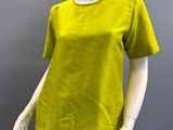 an image of a mannequin wearing a yellow top and black skirt